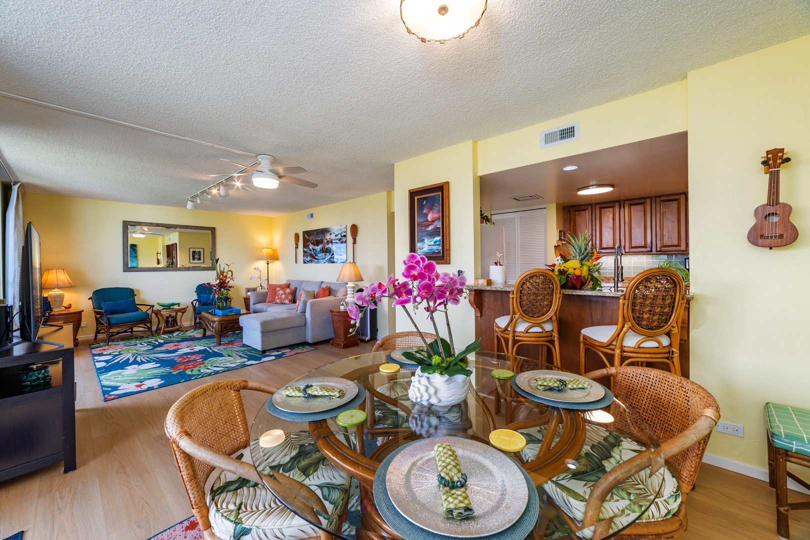 Step into your welcoming island retreat with tropical décor and thoughtful touches throughout. Relax in the open living space where vibrant orchids, comfortable seating, and beach-inspired art create a warm, inviting atmosphere for your getaway.