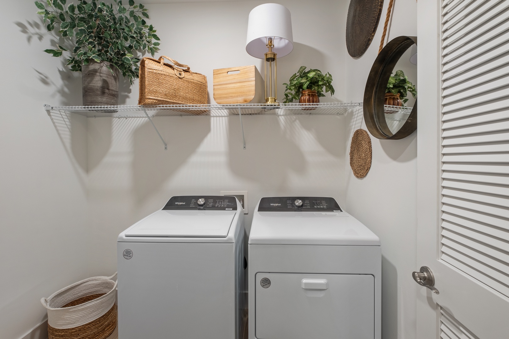 Your private laundry room features full-size washer and dryer with organized storage shelving above, making longer stays effortless.
