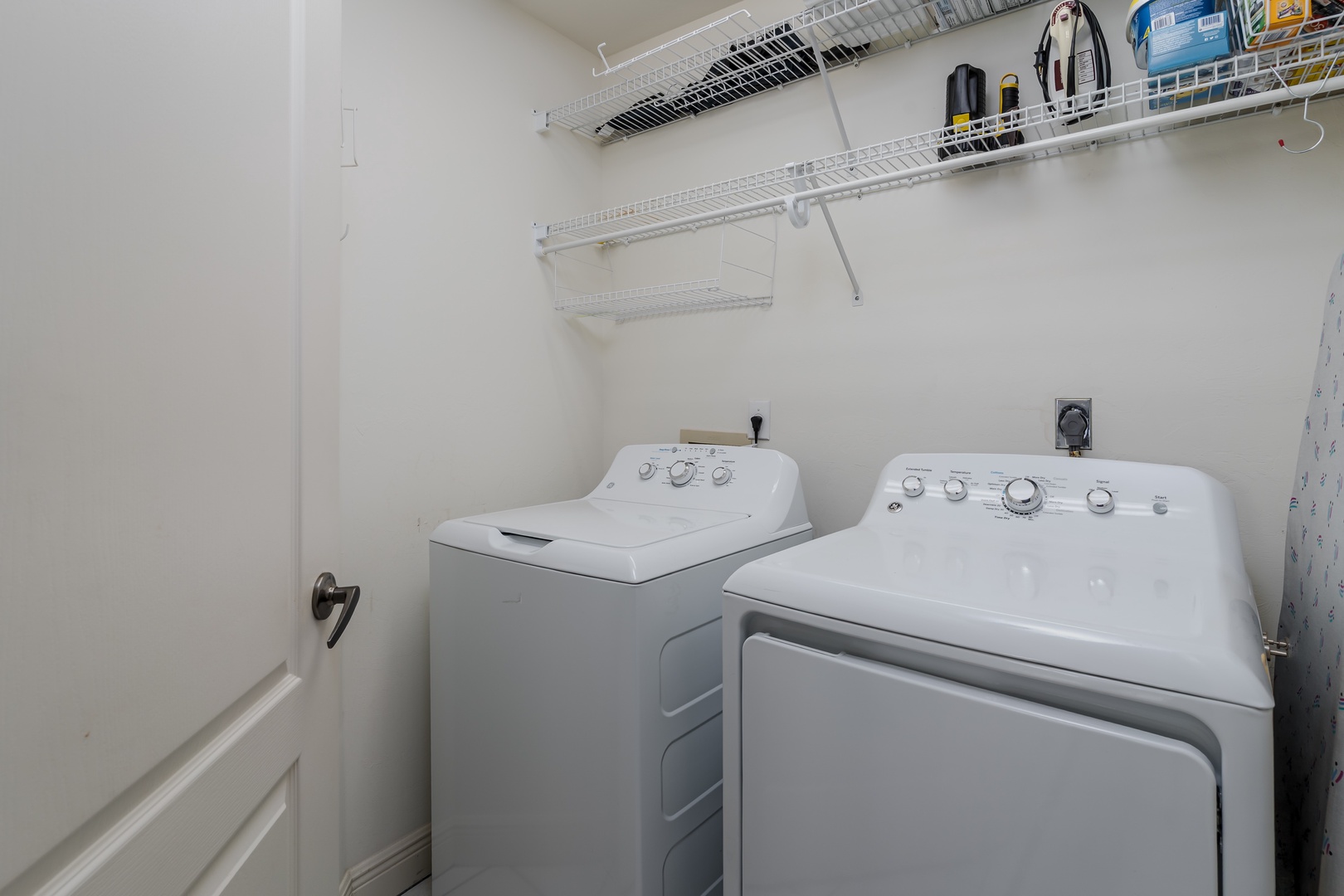 Your in-unit laundry room features a full-size washer and dryer, plus convenient overhead storage shelving—making it easy to refresh your wardrobe whenever you need during your stay.