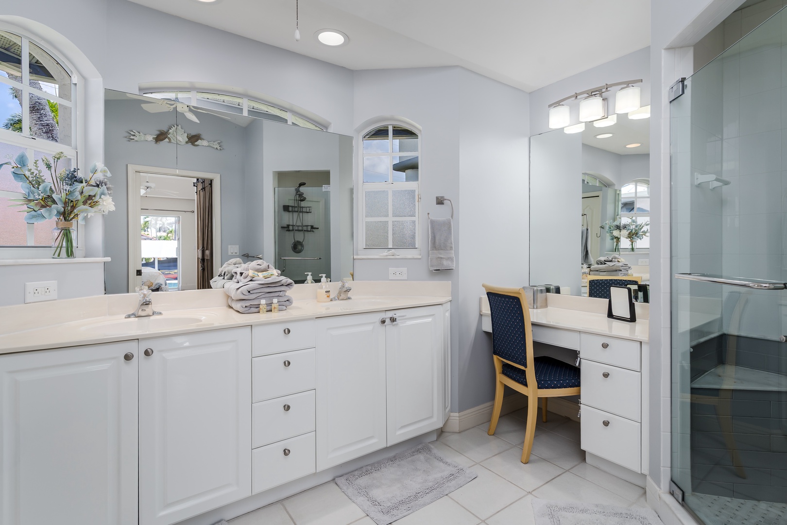 You'll love starting your mornings in this spa-like bathroom, where double vanities, soft linens, and elegant touches create a serene space to refresh before the day ahead.
