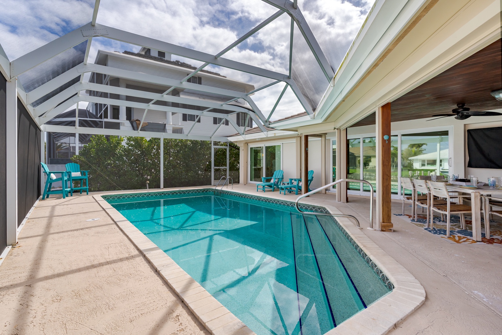 Dive into your private screened pool oasis, where turquoise waters and comfortable patio seating create the perfect Florida retreat.