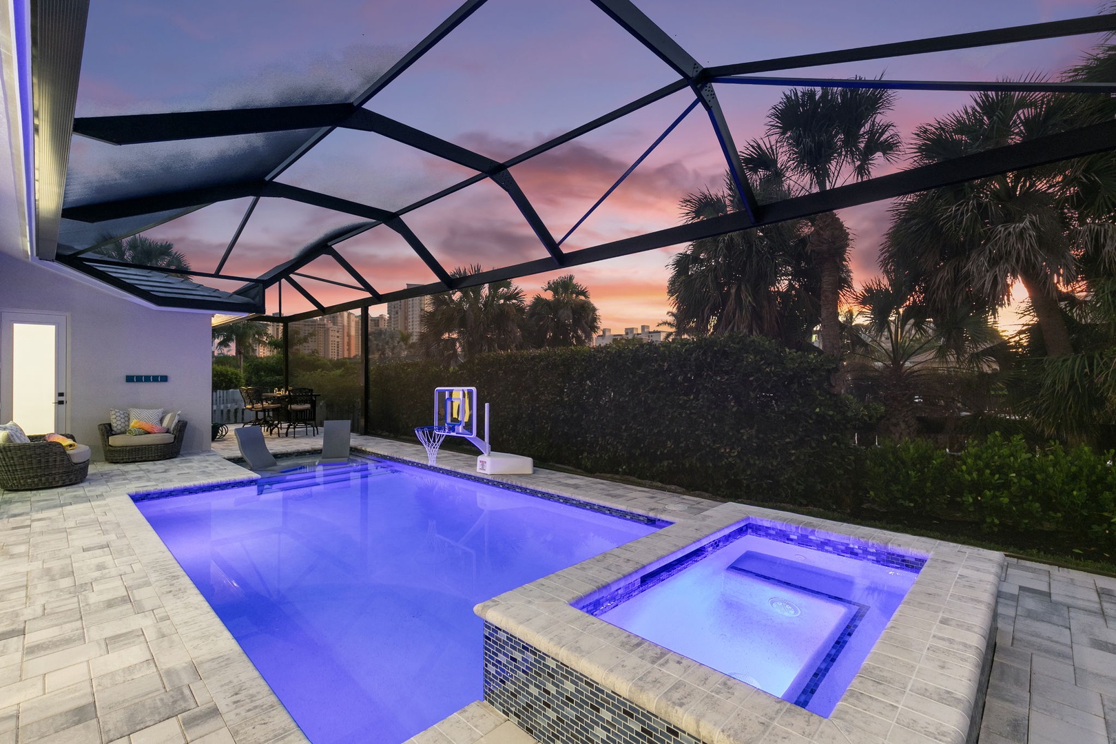 Drift away in your private pool and hot tub under a stunning sunset sky. The screened enclosure keeps you comfortable while you soak in the evening glow.