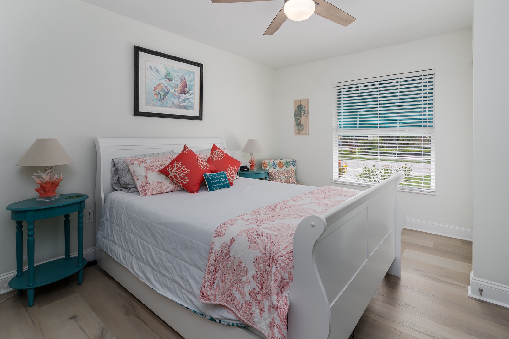 Drift off to sleep in your coastal-themed bedroom with coral accents, ocean views, and gentle ceiling fan breeze.