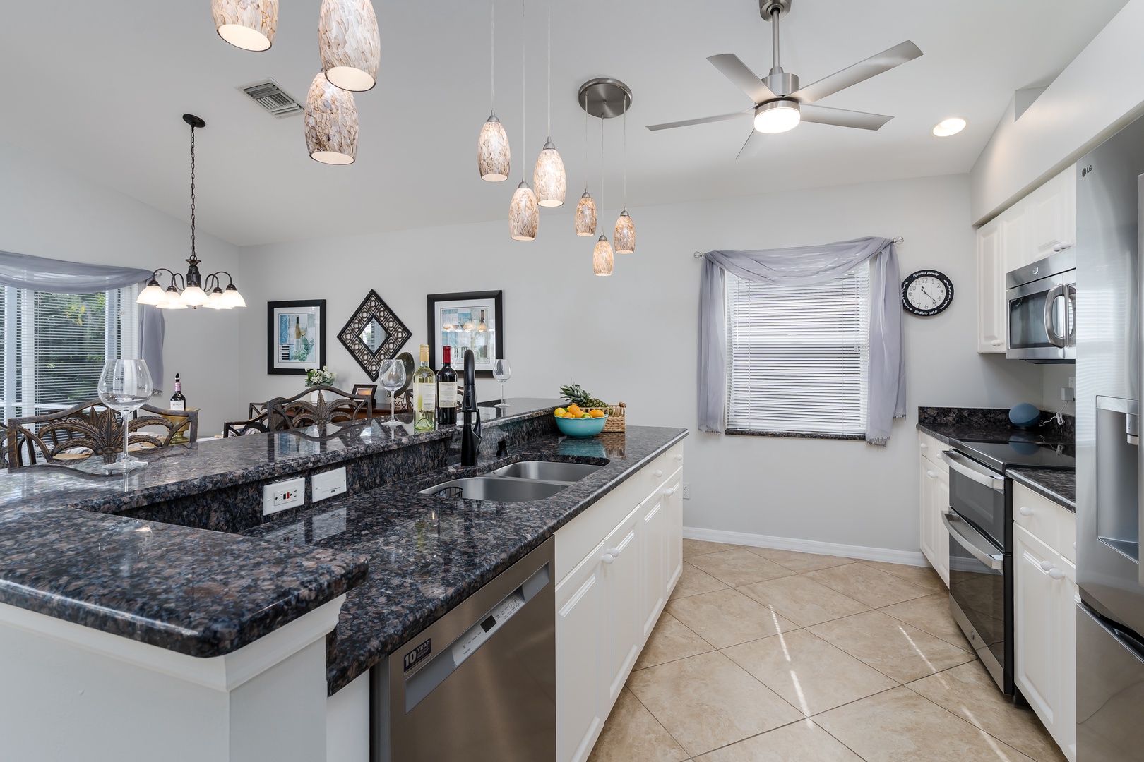 Cook your favorite meals in this stunning kitchen featuring granite countertops, stainless appliances, and elegant pendant lighting.