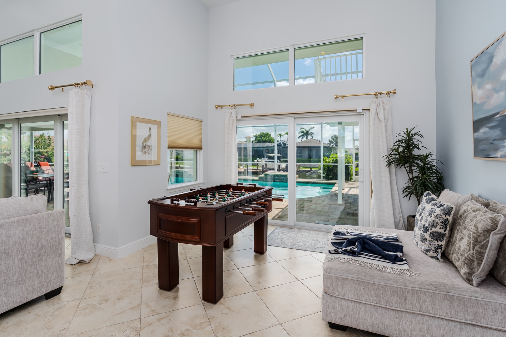 Challenge friends to foosball in your bright game room, where pool views create the perfect backdrop for friendly competition.