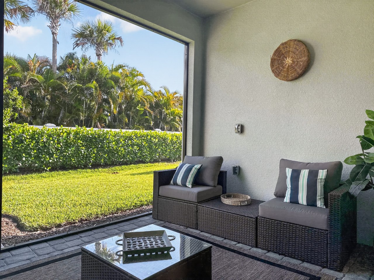 Sink into your private patio seating while gazing at lush tropical palms and manicured lawns—your peaceful escape awaits just beyond the glass.