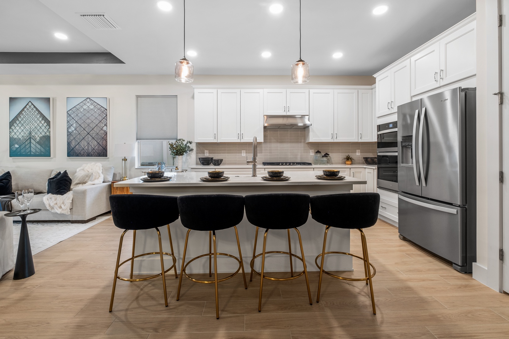 Your gourmet kitchen awaits with gleaming appliances, spacious island seating for four, and everything you need to create memorable meals together.