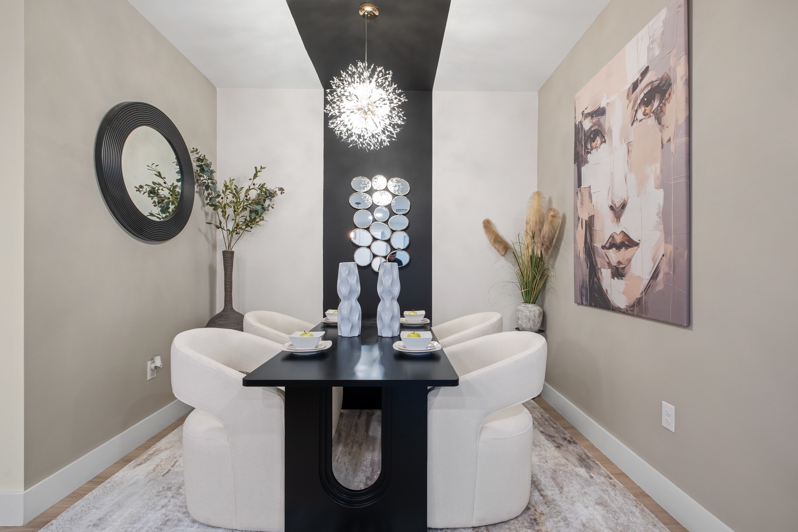 Indulge in intimate meals at your sleek dining table, where dramatic lighting and artistic touches create perfect moments together.