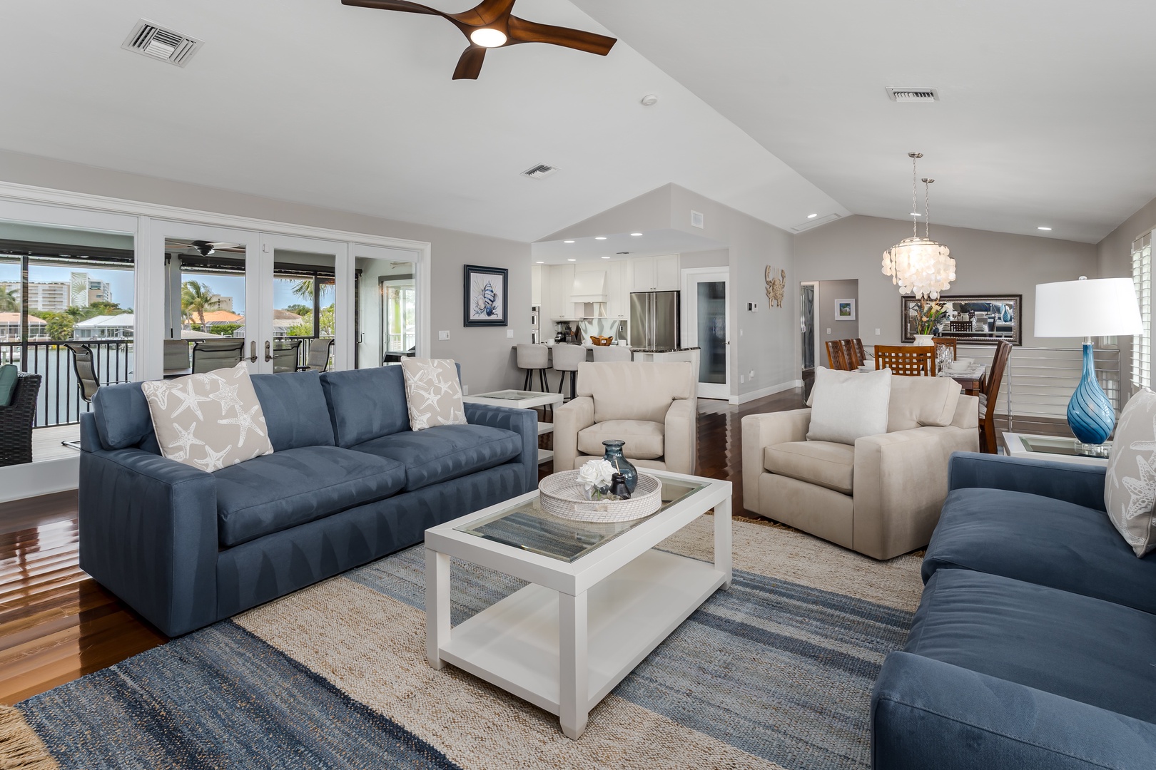 Unwind in your open-concept living space, where high ceilings, soft coastal tones, and abundant natural light create a serene retreat. Sink into plush seating after a day of adventure.
