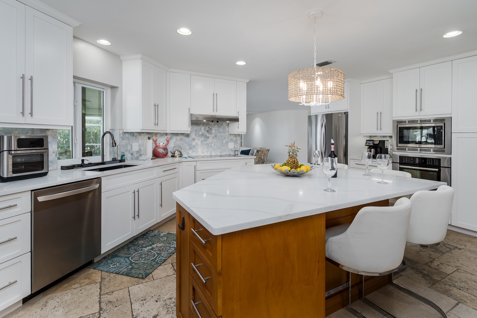 Your bright modern kitchen offers everything you need with stainless steel appliances, spacious island seating, and elegant lighting for memorable meal prep.
