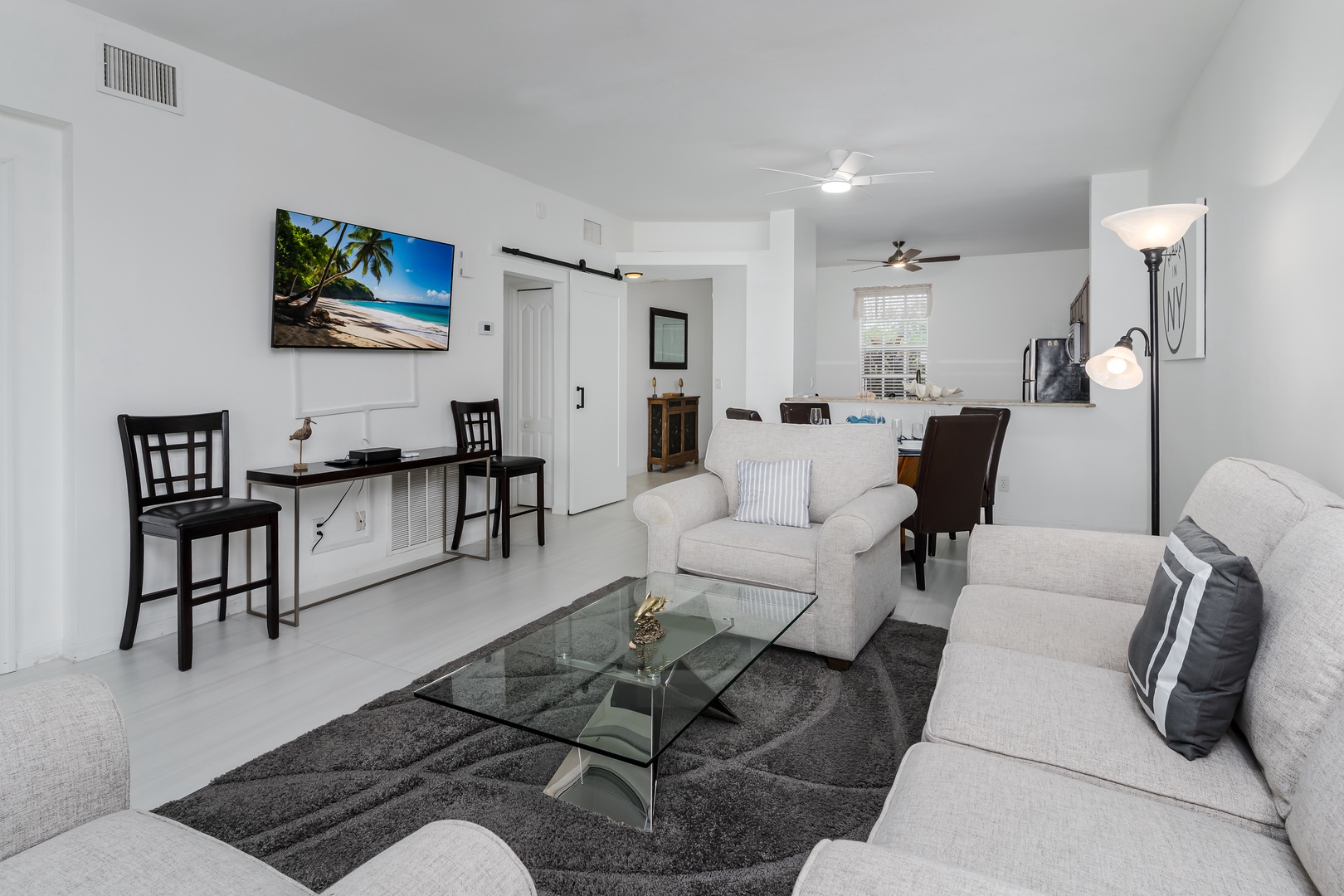Relax in your open-plan living space with plush seating, contemporary décor, and thoughtful touches that invite you to unwind after a day of exploring.