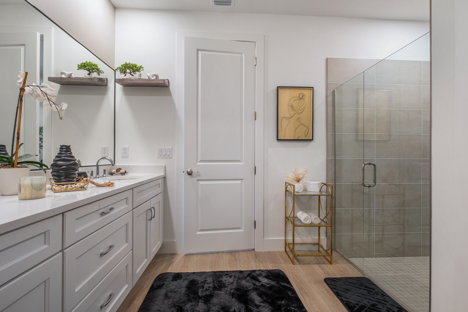 Step into your serene spa-like bathroom with elegant white cabinetry, spacious walk-in shower, and thoughtful touches that make your morning routine feel luxurious.
