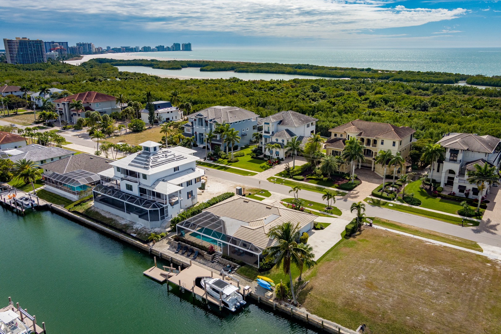 Exclusive waterfront neighborhood with luxury homes, private docks, and tropical landscaping along pristine coastal waters.