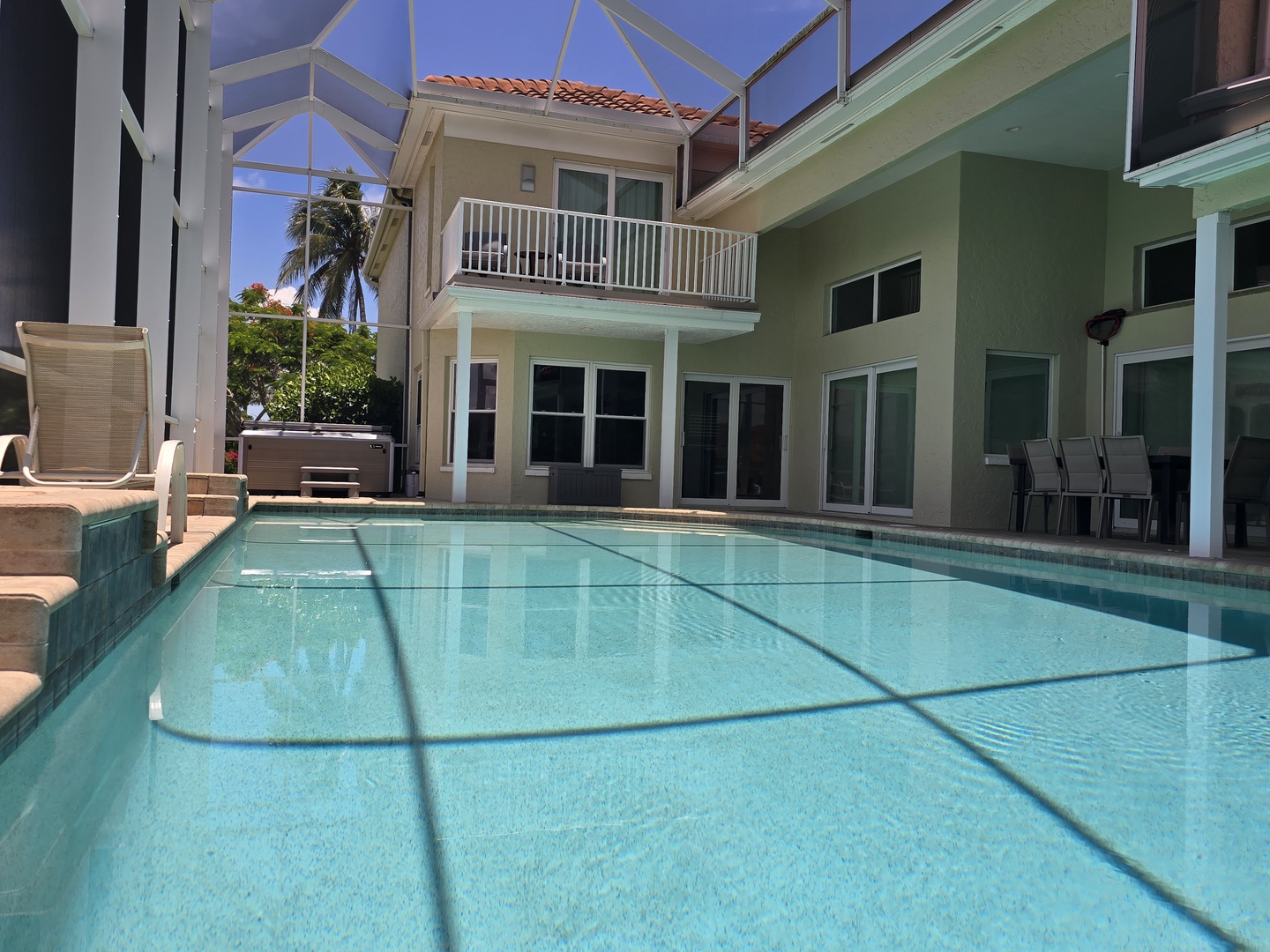 South Facing View of Pool and Hot Tub in Lanai and Master Suite Balcony