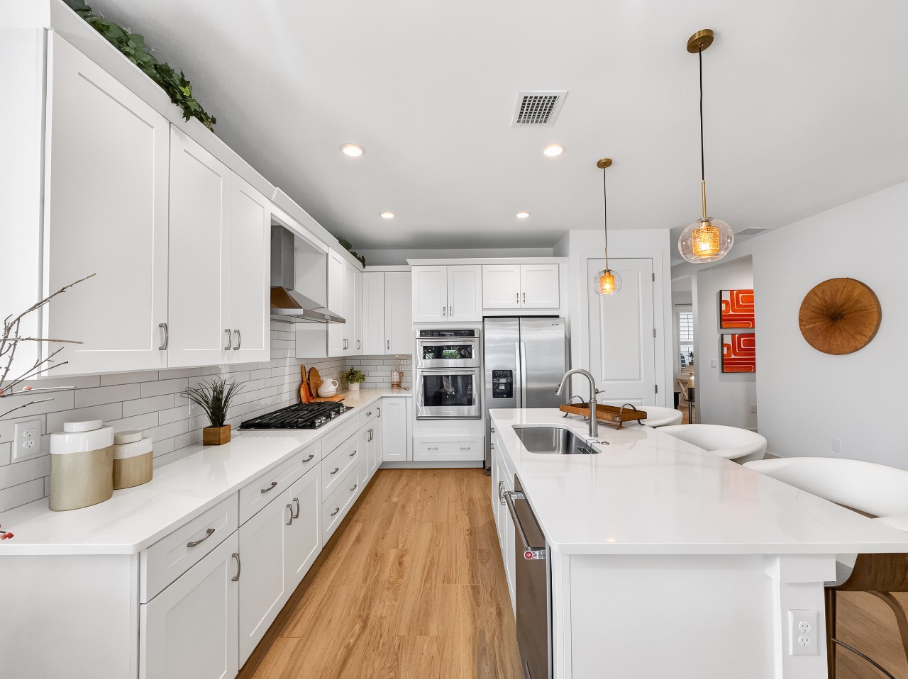 Step into your fully equipped gourmet kitchen with modern appliances, sleek white cabinetry, and plenty of counter space for preparing memorable vacation meals together.