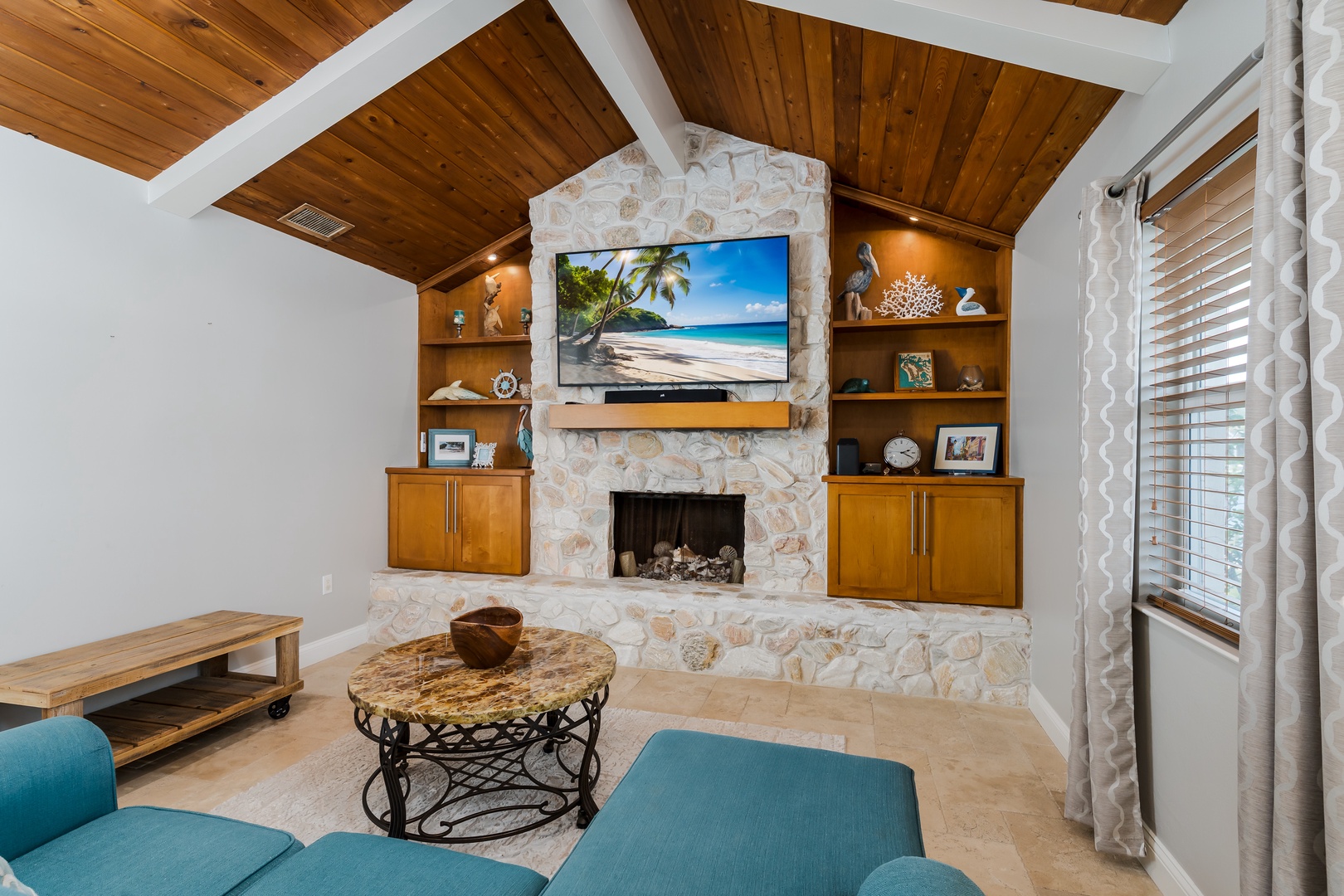 Cozy up by your stone fireplace while enjoying your favorite shows on the large TV in this inviting living space.