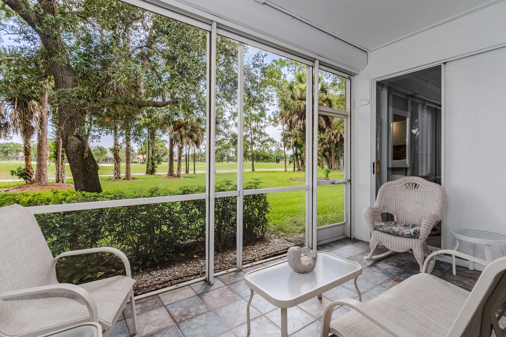 Relax in your screened lanai with garden and golf course views stretching beyond, where peaceful afternoons unfold in comfort and every sunrise invites a fresh breath of Florida air.
