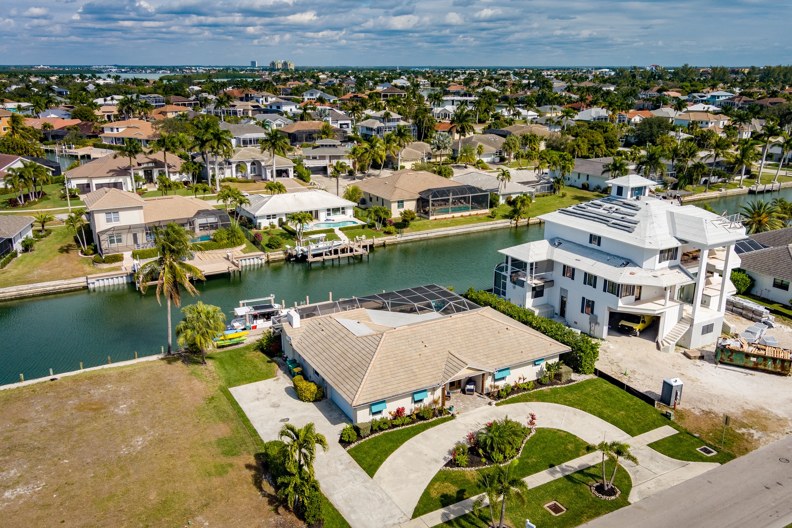Waterfront community with palm-lined homes, boat access, and peaceful canal views in sunny South Florida.