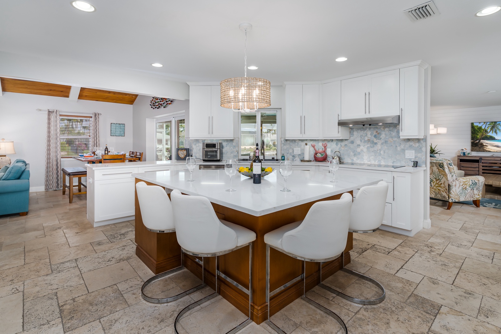 Your spacious open-concept kitchen features modern white cabinets, quartz countertops, and a stunning island perfect for preparing meals together.
