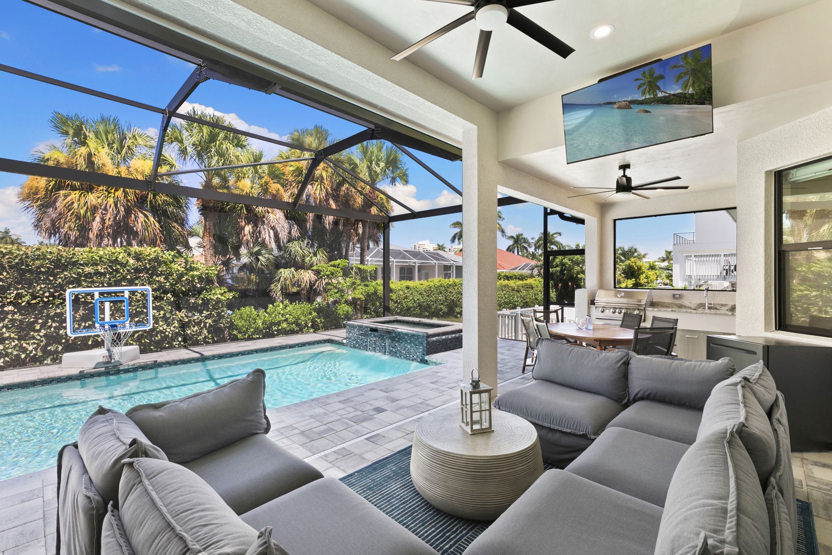 Relax under the lanai, where plush seating invites you to unwind by your private pool and spa, surrounded by lush palms and Florida sunshine.