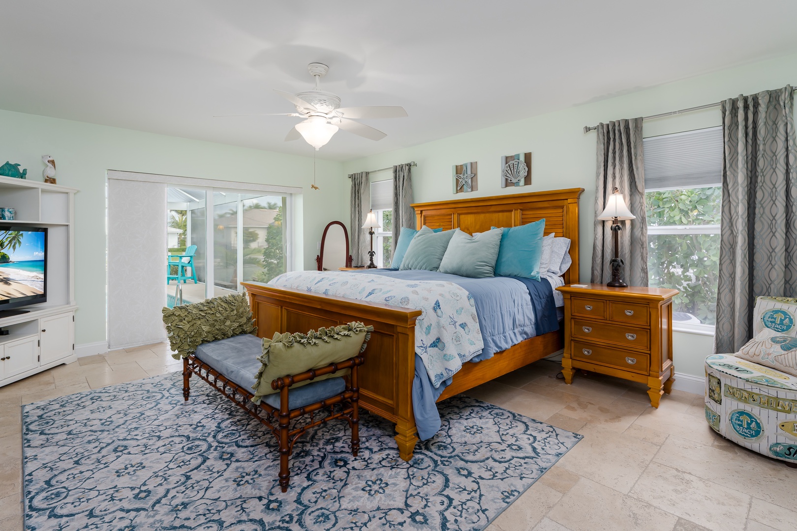 Unwind in your serene master bedroom where coastal blues meet warm wood tones, creating the perfect sanctuary for peaceful nights.