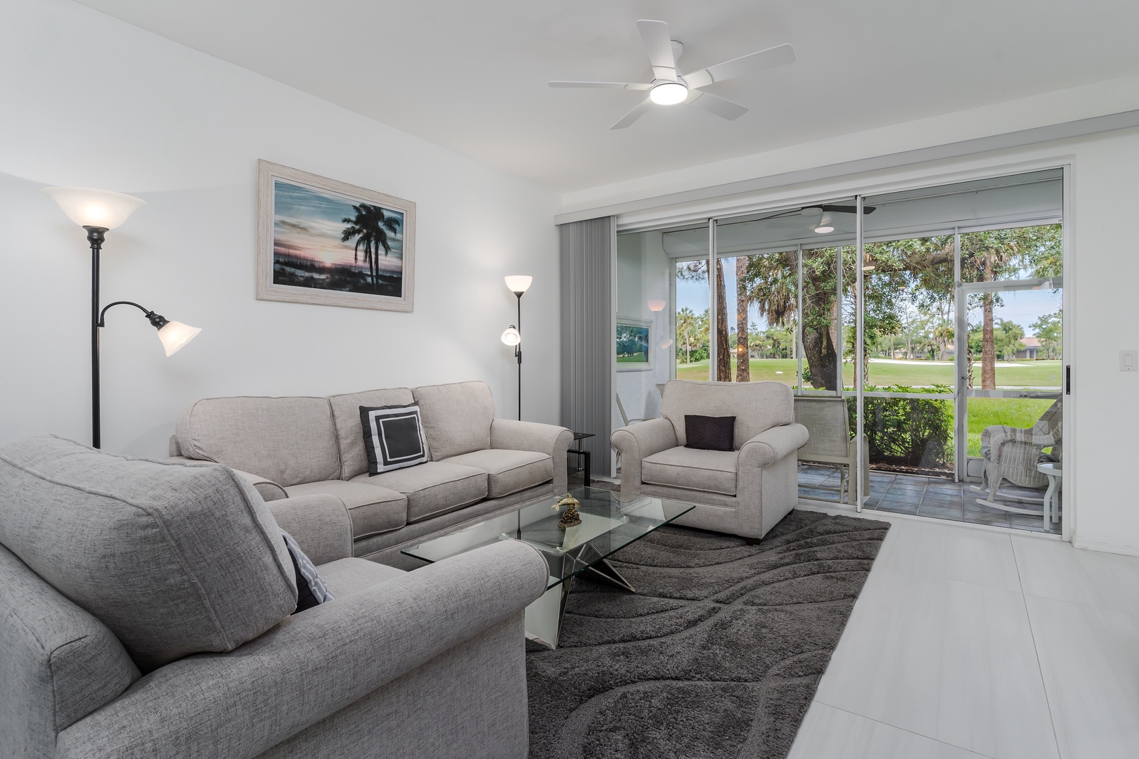 Settle into plush seating and soak in peaceful park views through your sliding glass doors. A ceiling fan and soft lighting create the perfect atmosphere for your downtime.