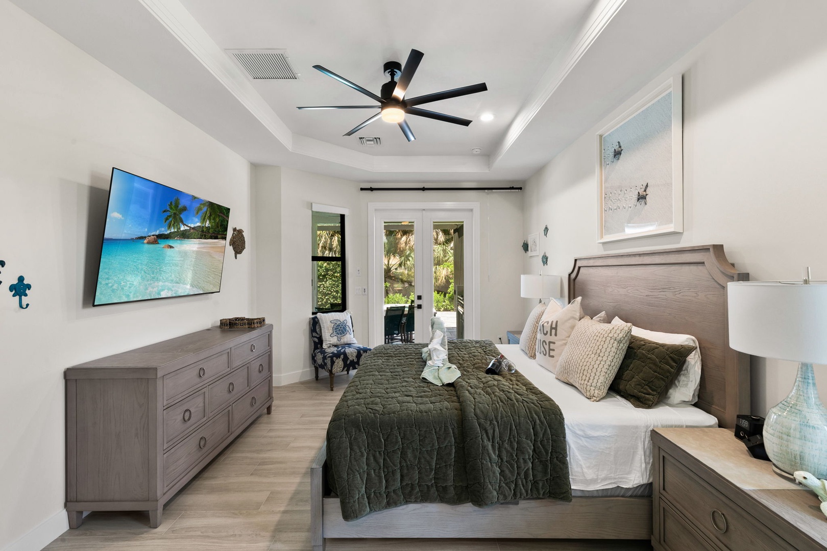 Wake up in this serene bedroom where natural light filters through French doors and a soothing color palette invites deep rest. Your private outdoor space awaits just steps away.