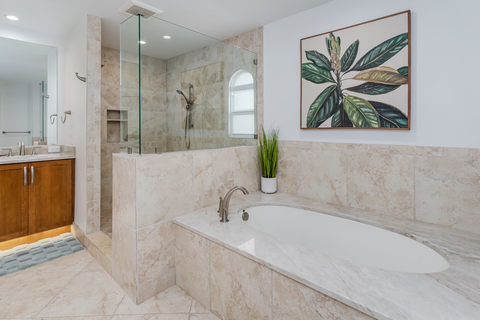 Unwind in your spa-like bathroom with a deep soaking tub and luxurious walk-in shower featuring elegant marble finishes.