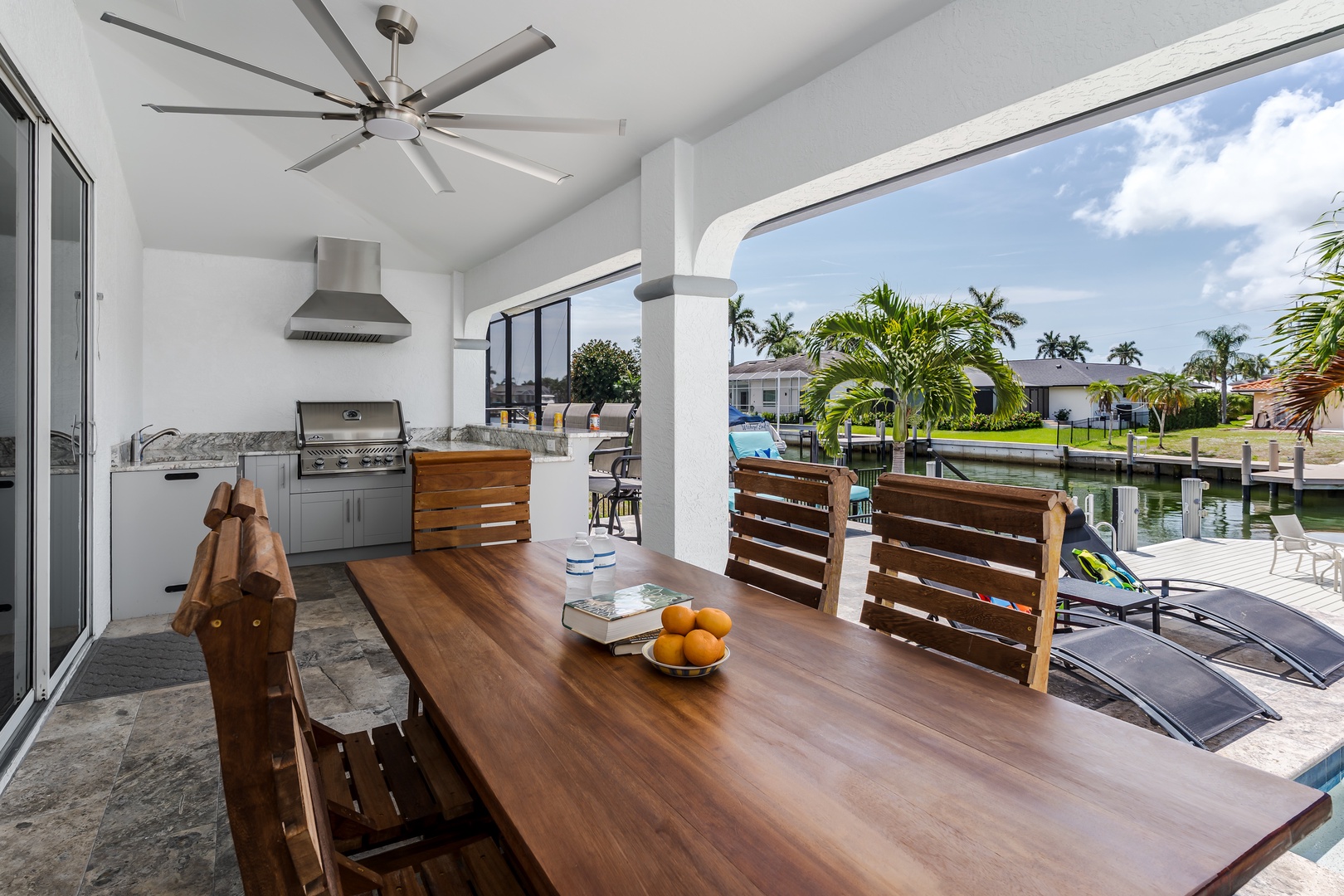 Enjoy meals together at your private outdoor dining area, complete with a full BBQ setup, overlooking tranquil canal views and your own pool deck—perfect for al fresco entertaining.