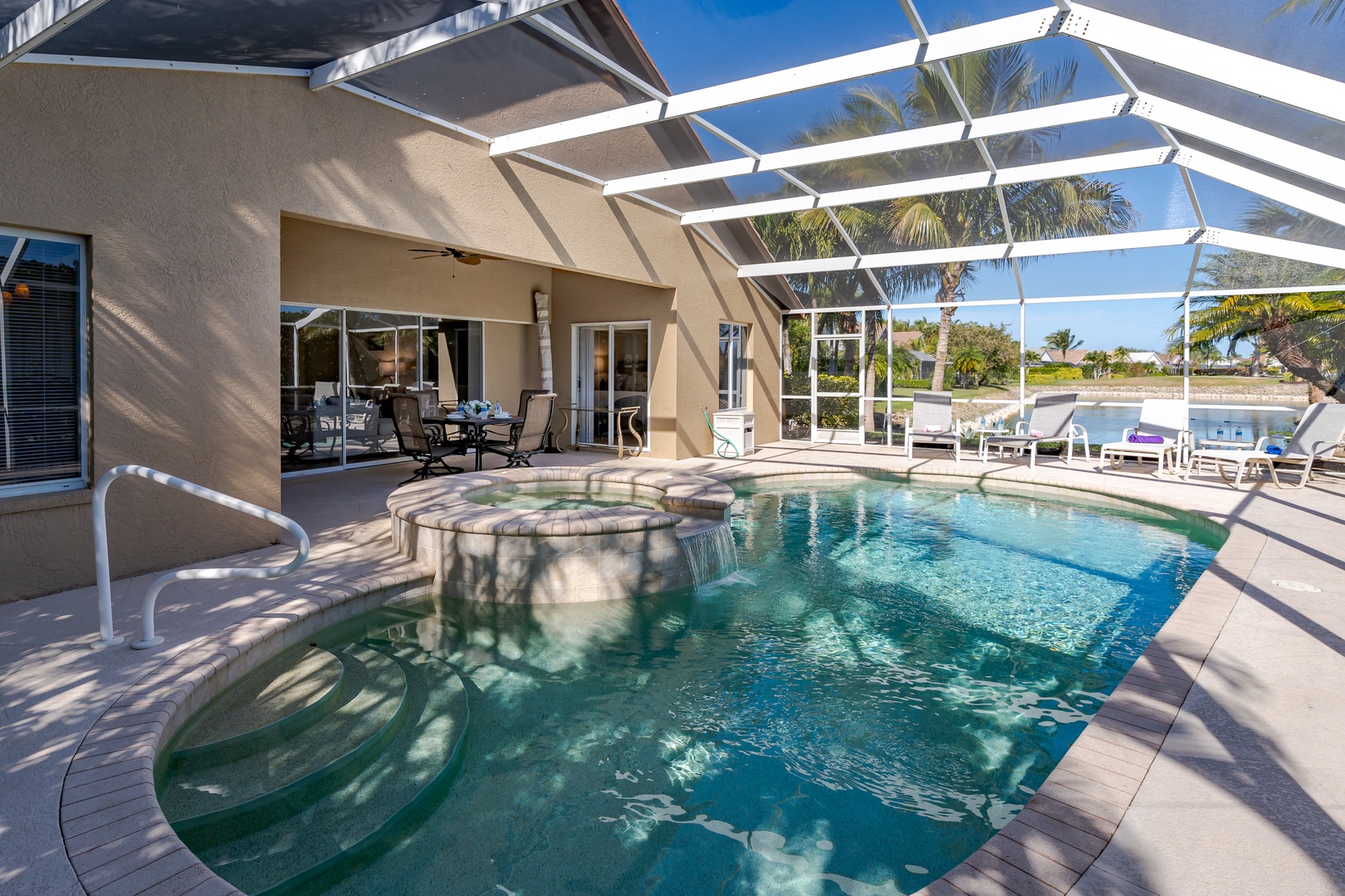 Your private screened pool sanctuary awaits, complete with a bubbling spa and comfortable loungers for endless relaxation under the Florida sun.
