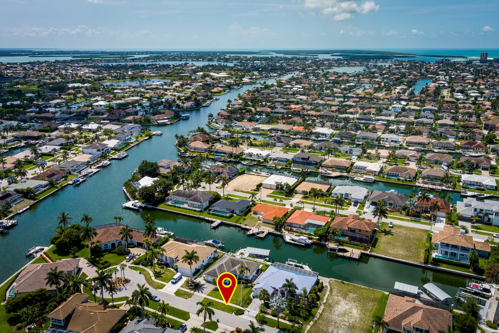 Coastal waterfront community featuring interconnected canals and direct water access, with tropical landscapes and ocean views defining this vibrant neighborhood.