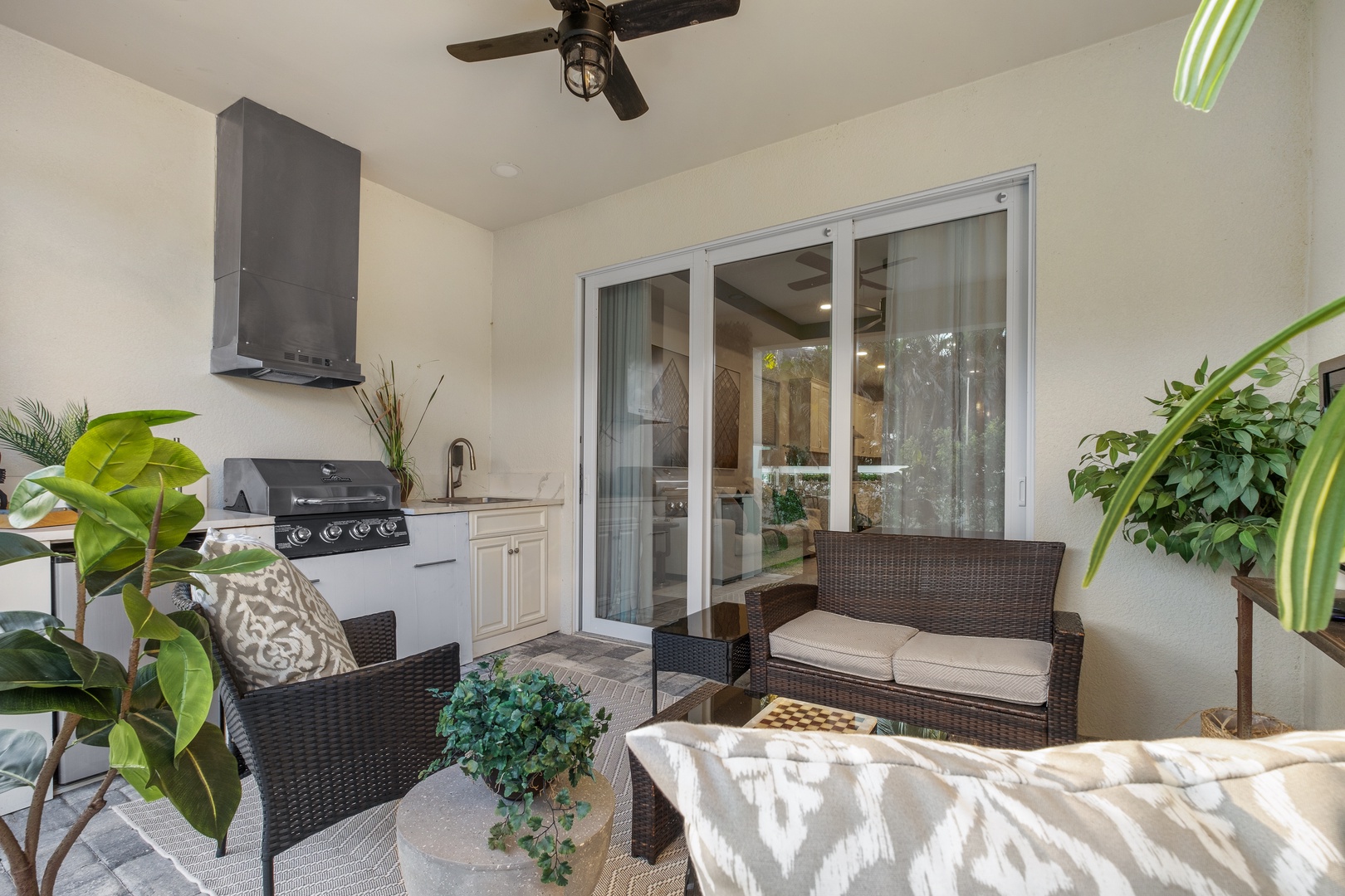 Your private outdoor oasis awaits with a fully-equipped kitchen, comfortable seating, and lush greenery creating the perfect space for al fresco dining.
