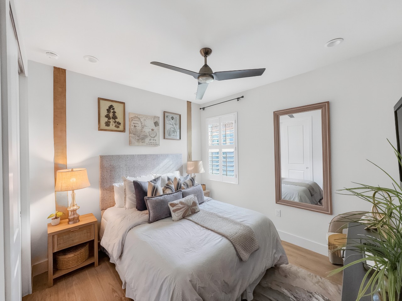 Sink into crisp linens and plush pillows in your peaceful bedroom retreat, where natural light and coastal-inspired decor create the perfect atmosphere for restful nights.