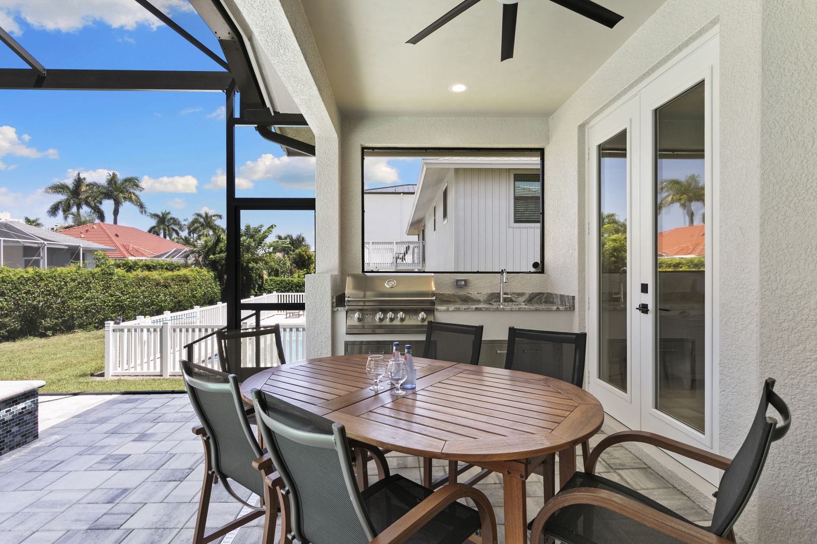 Step outside to your private covered patio, where a sleek built-in grill awaits your culinary creations. Gather around the spacious dining table and soak in the tropical surroundings—perfect for alfresco meals and sunny afternoons.