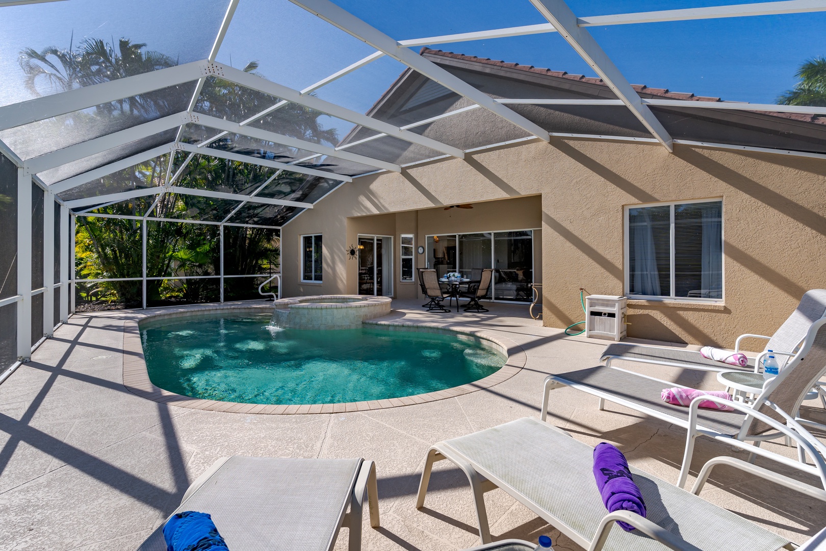 Your private oasis awaits with a sparkling pool under a screened lanai, complete with comfortable lounge chairs for ultimate relaxation.