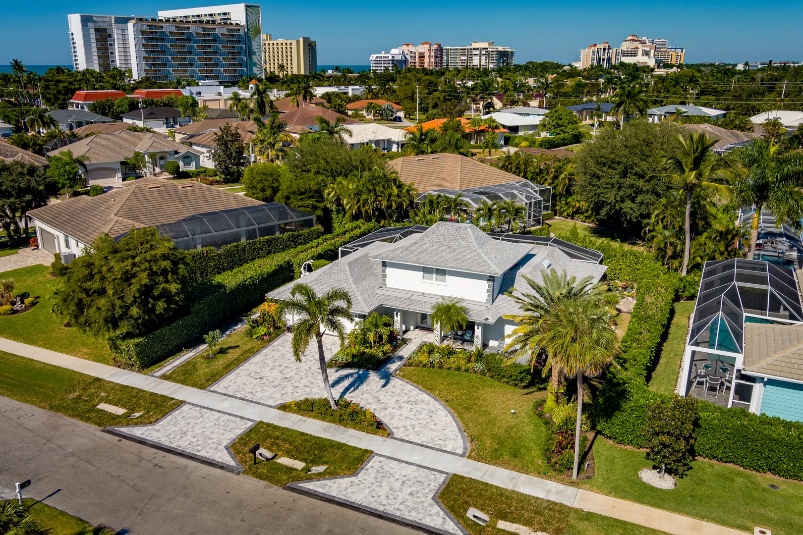 Tropical coastal neighborhood with luxury resorts and palm-lined residential streets creating a peaceful vacation setting.
