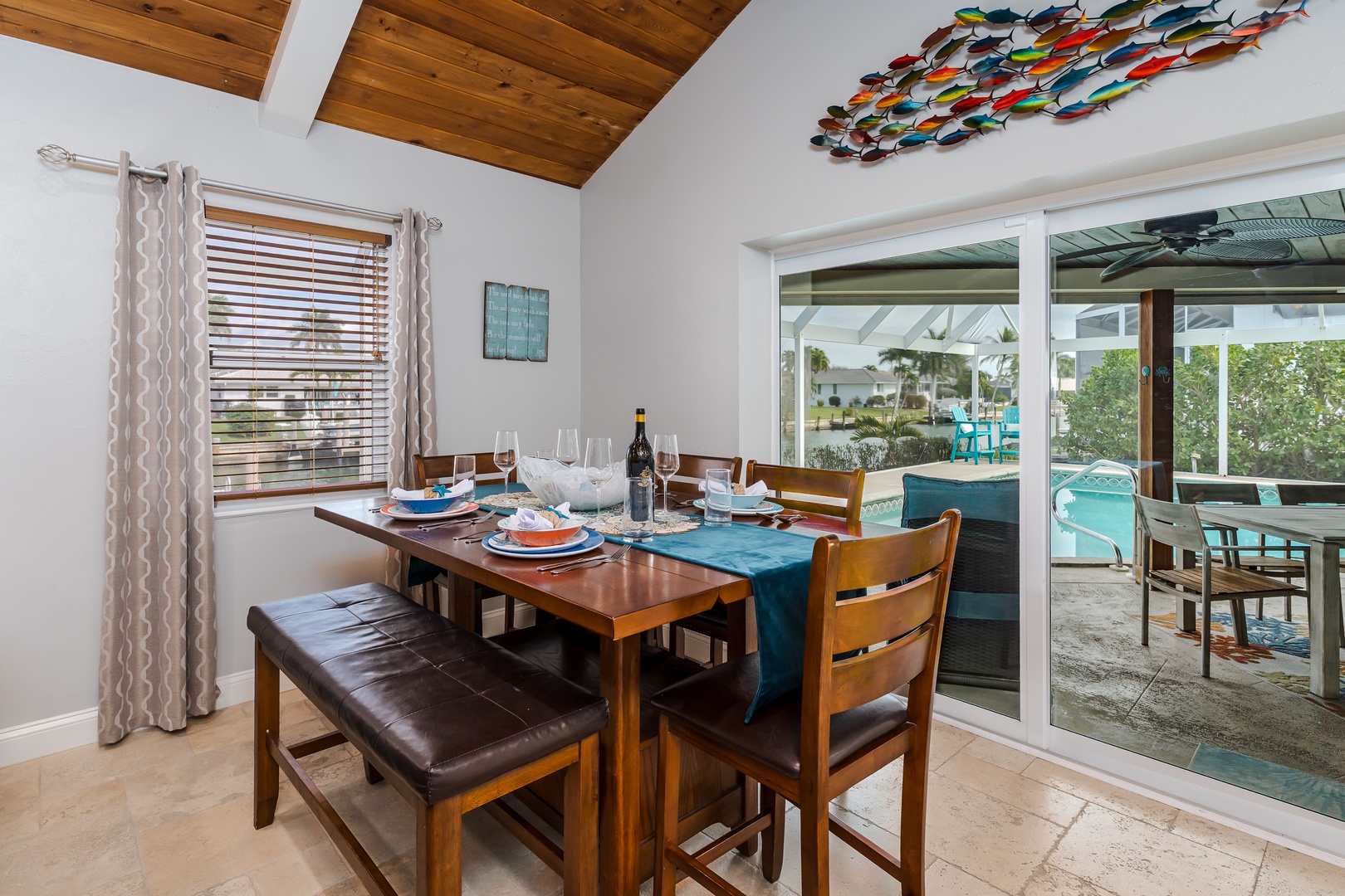 Gather around this elegant dining table where memorable meals await, with stunning wood ceilings and poolside views creating the perfect backdrop for your vacation dining.