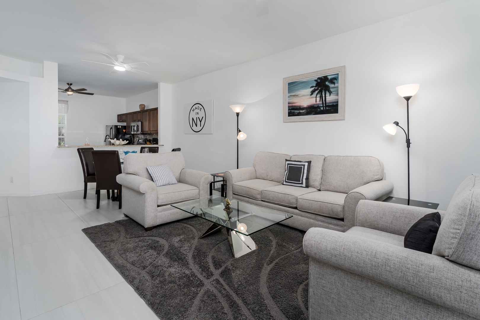 You'll feel right at home in this bright, inviting living space with comfortable seating for relaxing after a day of exploring. The open layout flows into the dining area and kitchen, making it perfect for unwinding together.