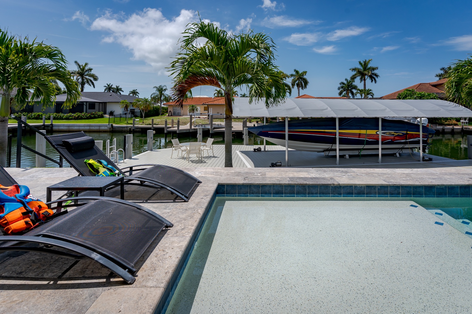 A waterfront paradise with tropical palms, private pool, and boat dock—your perfect escape awaits. Relax poolside, explore the canal, or unwind in this sun-soaked oasis.