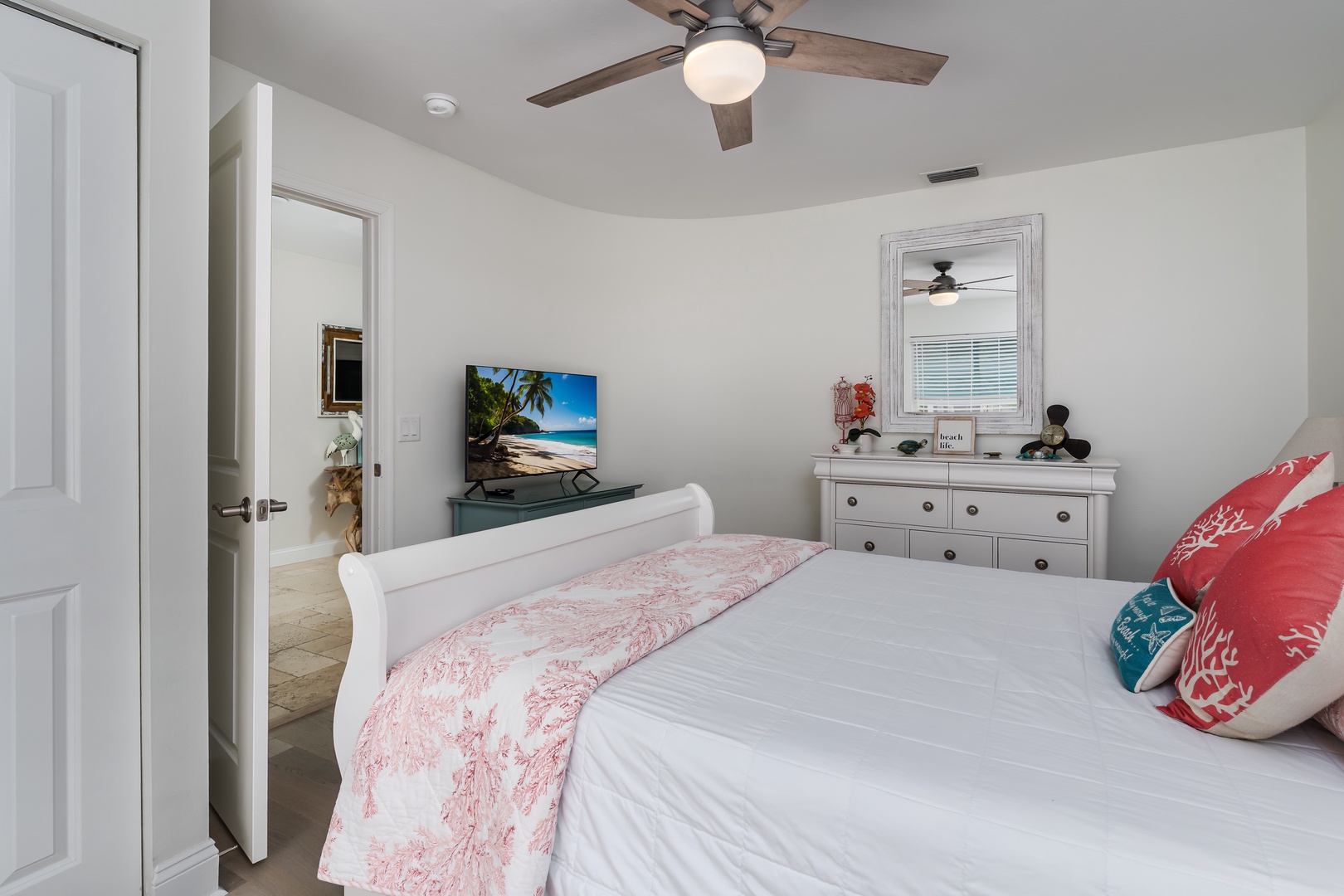 Your bright bedroom features a comfortable bed with tropical touches, dresser storage, and entertainment center for ultimate relaxation.