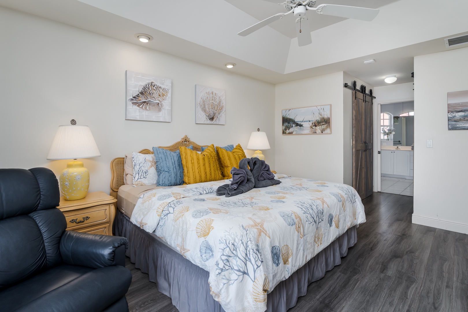 Drift off in this coastal-inspired bedroom where ocean hues meet warm accents. Vaulted ceilings, a plush bed with beach-themed linens, and thoughtful touches create your peaceful retreat after sun-filled days.