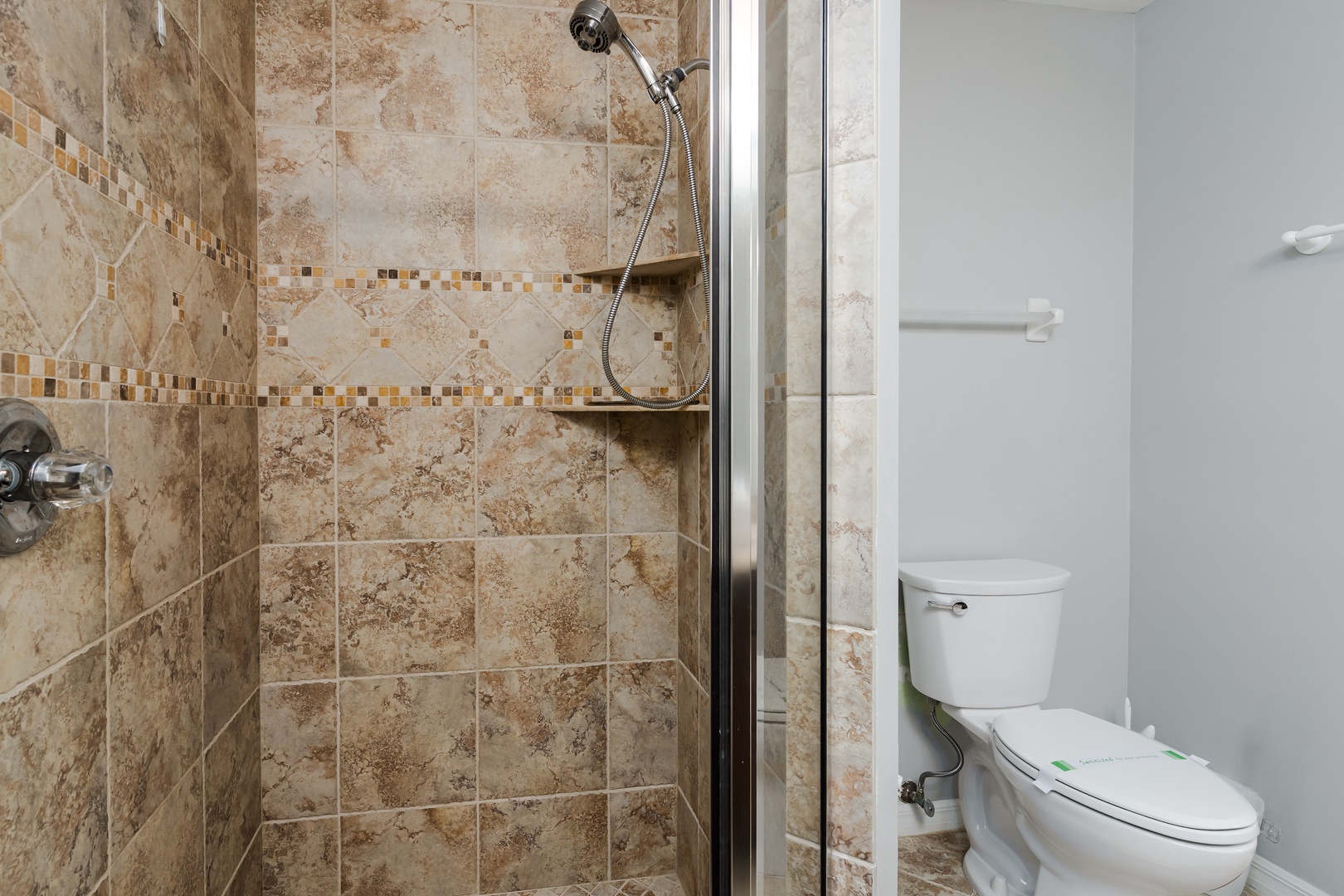 Freshen up in your beautifully tiled walk-in shower with handheld showerhead and built-in shelving for your essentials.