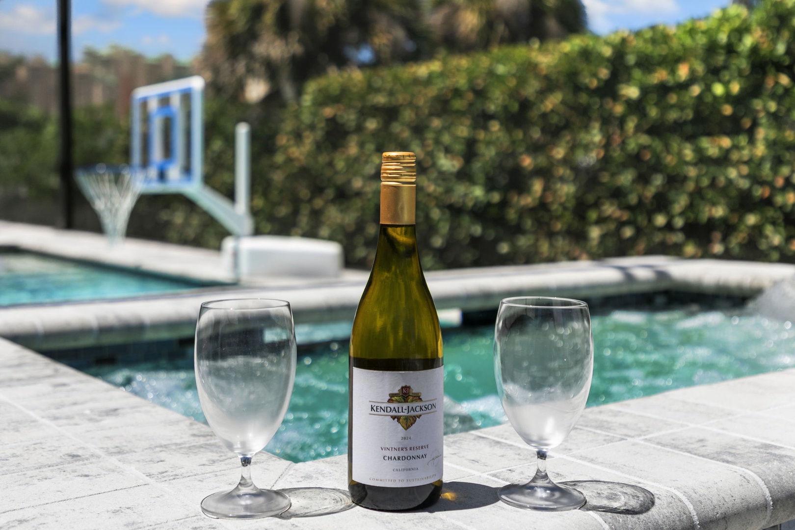 Imagine poolside moments with your favorite drink in hand. The sparkling water and sunny deck invite leisurely afternoons spent relaxing, sipping, and soaking in the good life.