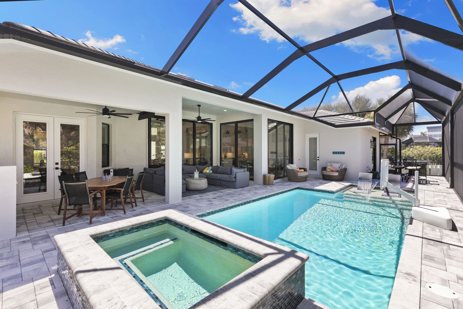 Imagine yourself relaxing by your private pool and hot tub under a spacious screened lanai, perfect for soaking up Florida sunshine while staying cool. The open patio offers plenty of space for dining and lounging just steps from the water.
