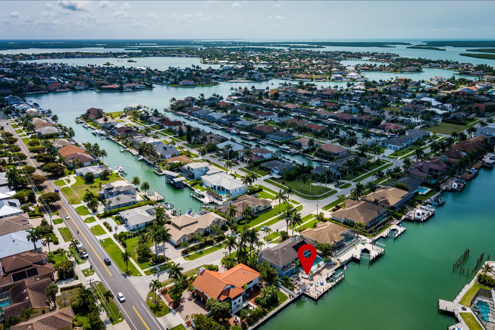 Aerial view of a waterfront vacation rental community with canal access and private boat docks along scenic Florida waterways.