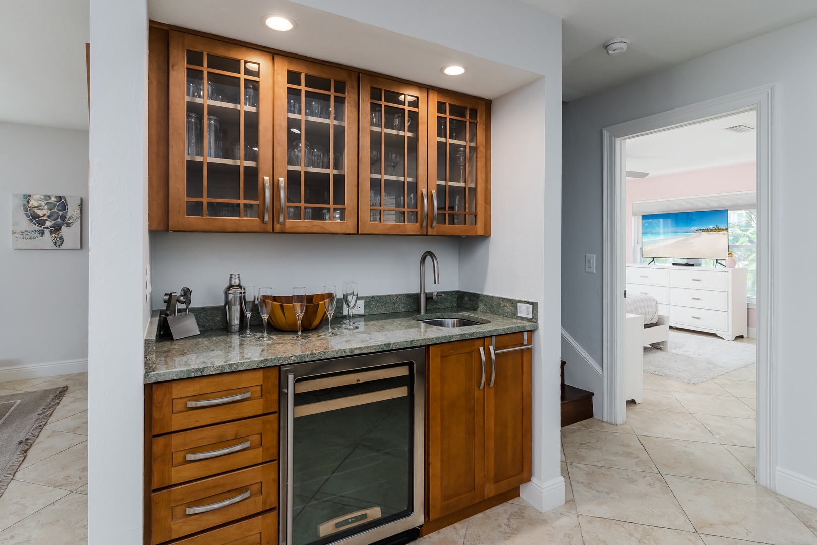 Your stylish wet bar features warm wood cabinetry, granite counters, and wine storage—perfect for evening cocktails.