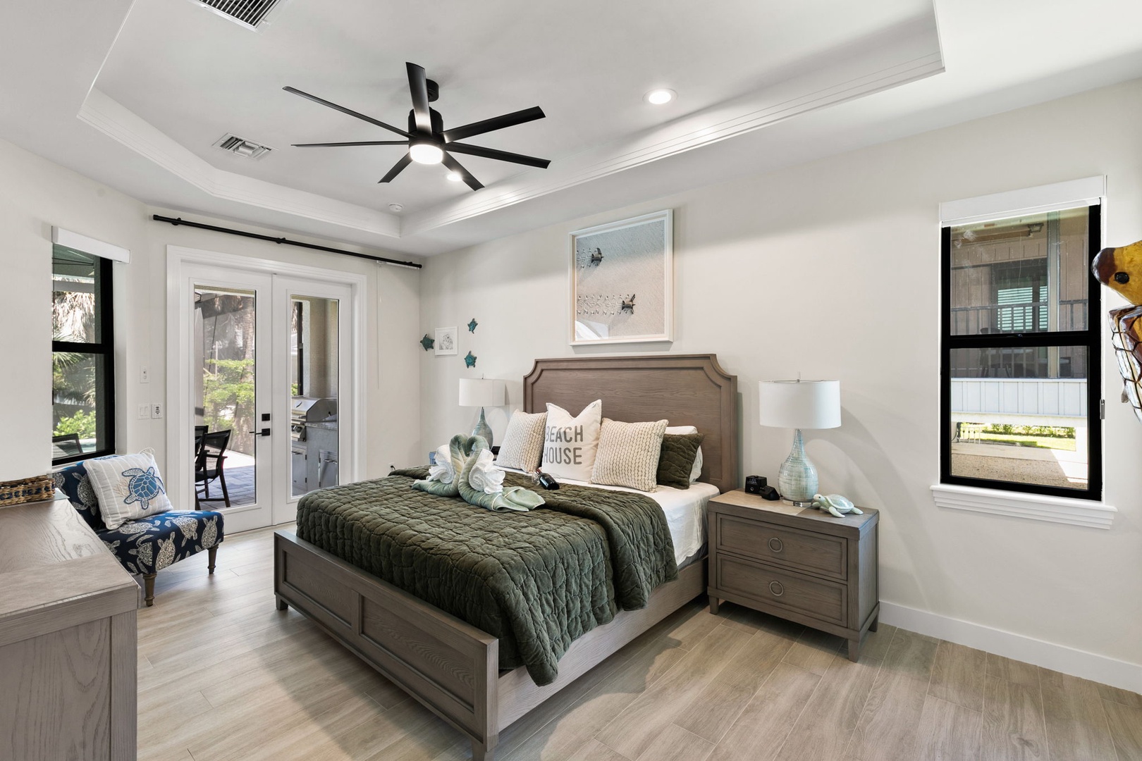 Drift off under the gentle whir of your ceiling fan, wrapped in soft bedding and coastal-inspired decor. Patio doors invite natural light and fresh breezes into your serene retreat.