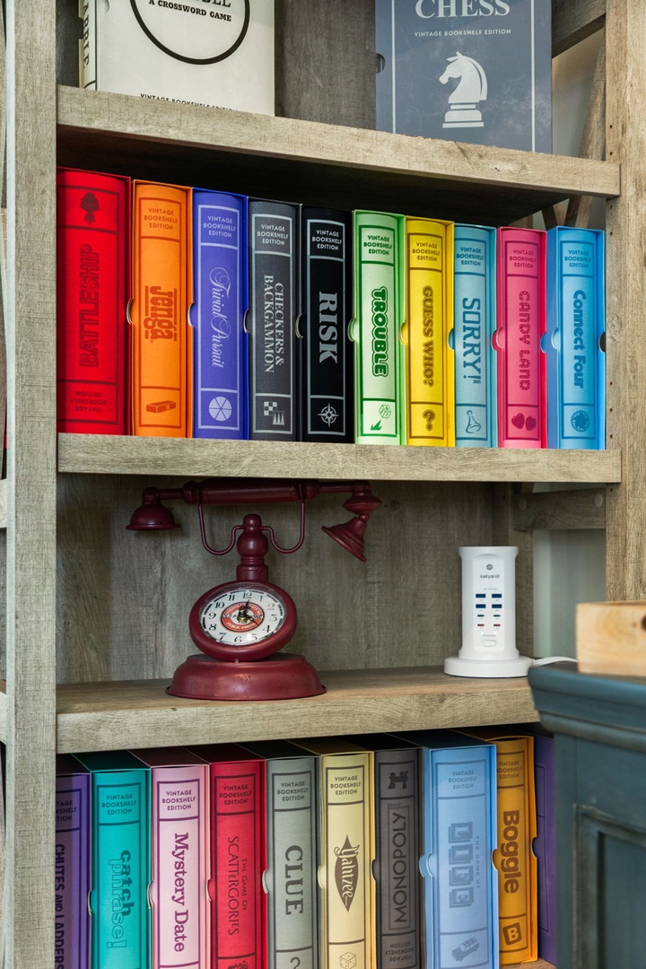 Challenge your travel companions with classic board games and puzzles beautifully arranged on rustic wooden shelving—perfect for cozy game nights together.
