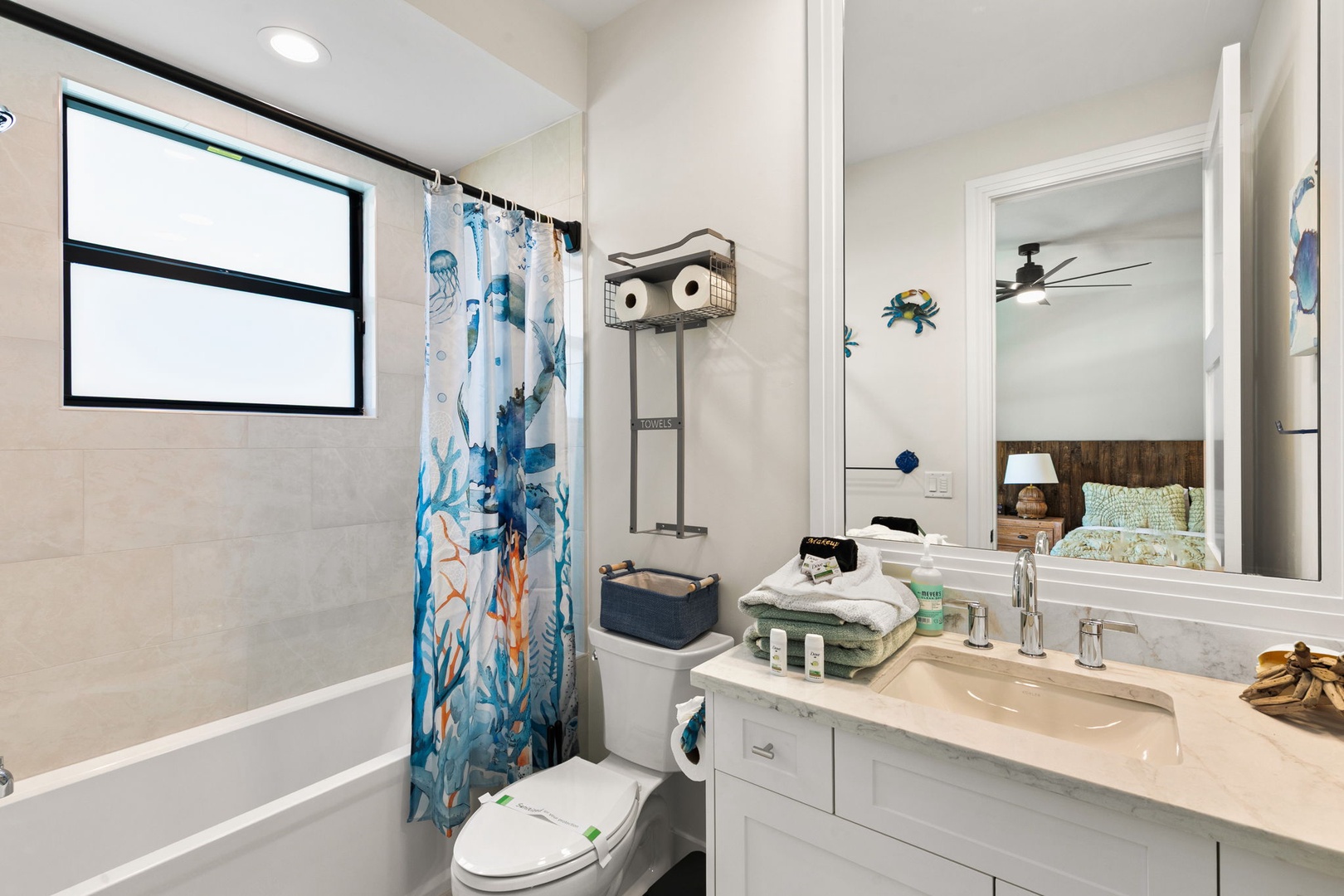 Step into your coastal retreat where ocean-inspired touches meet sparkling clean comfort. The bright bathroom features a soaking tub, fresh linens, and charming nautical details to welcome you home after a day of beachside adventures.