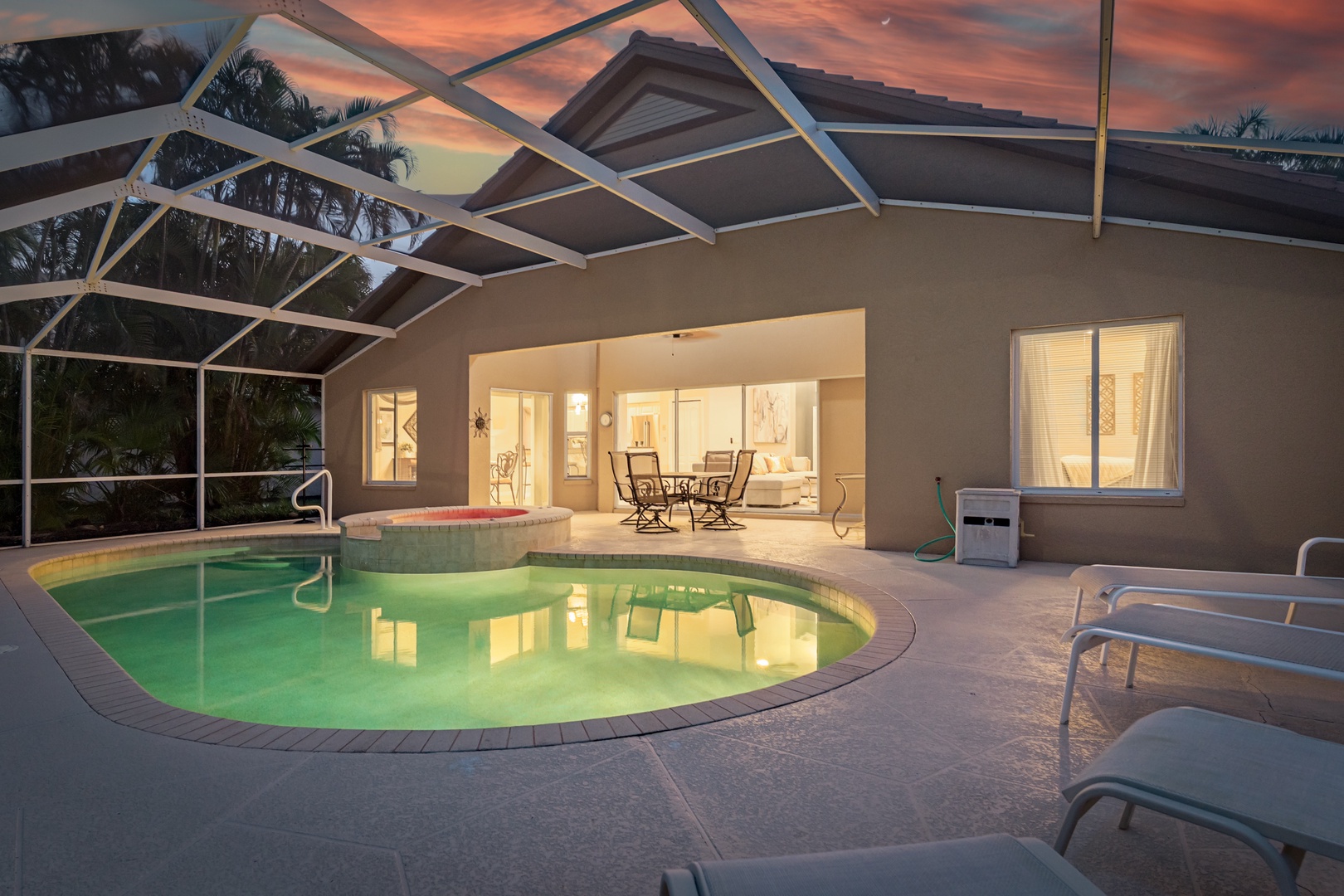 Beautiful screened pool area captures stunning sunset views while connecting seamlessly to comfortable indoor living spaces.